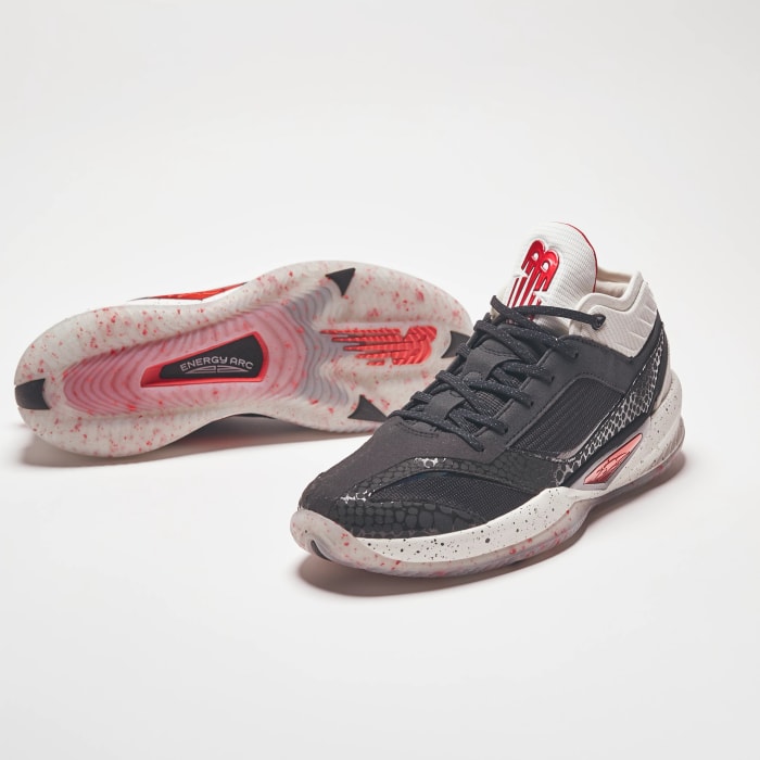 View of black, white, and red New Balance shoes.